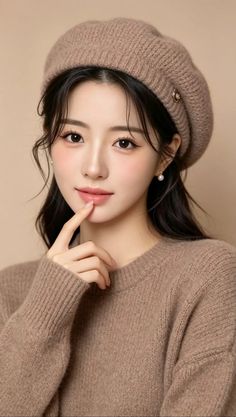 Woman in a brown beret and sweater with pearl earrings, finger to lips