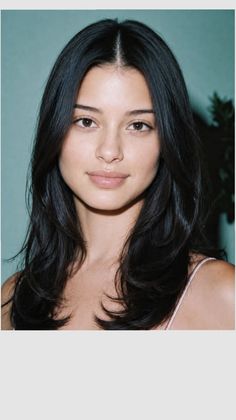 Woman with long black hair and natural makeup in a soft lighting portrait
