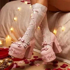 Pink platform shoes with bows and knee-high socks in a romantic setting