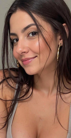 Woman with long dark hair and gold earrings smiling at the camera