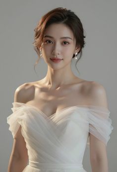 Woman in a white off-shoulder wedding dress with pearl earrings
