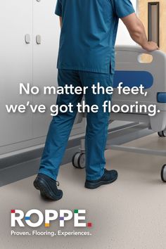 Person in medical scrubs pushing a hospital bed in a clean room