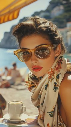 Woman in sunglasses and a floral scarf at a beachside cafe