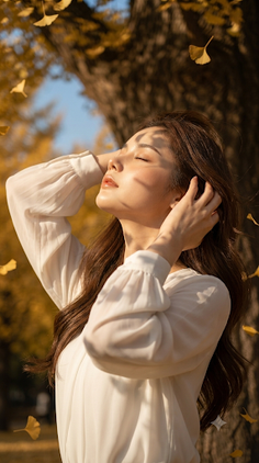 Woman with long hair in a white blouse enjoying the sun outdoors