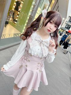 Woman in a pink dress with twin tails on a street