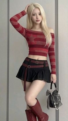 Woman with blonde hair wearing a crop top and mini skirt with red boots