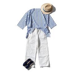 A casual summer outfit with a striped shirt, white pants, straw hat, and blue shoes