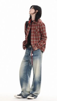 Person in a red plaid shirt and baggy jeans looking up