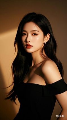 Woman with long black hair wearing an off-shoulder black dress and pearl earrings