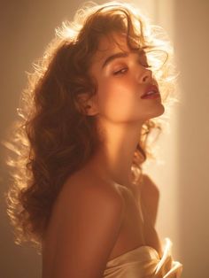 Woman with curly hair bathed in golden hour light