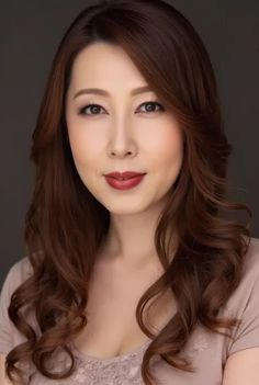 Woman with long wavy hair and red lipstick in a portrait shot