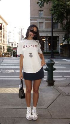 Woman in a white t-shirt and mini skirt on a city street