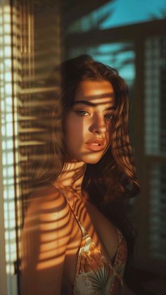 Woman with long hair in a bikini with golden hour lighting and shadow patterns