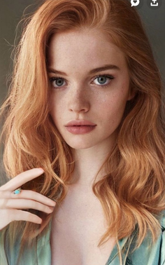 Woman with red hair and freckles wearing a turquoise ring
