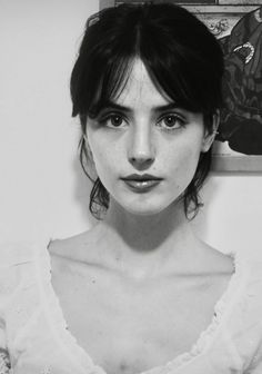 Black and white portrait of a woman with dark hair and a white top