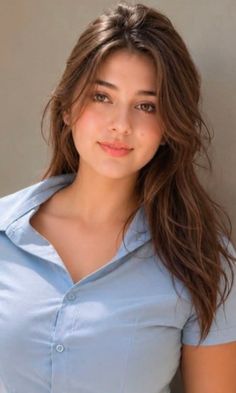 Woman with long brown hair wearing a blue collared shirt