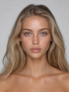 Blonde woman with blue eyes and long hair in a studio portrait