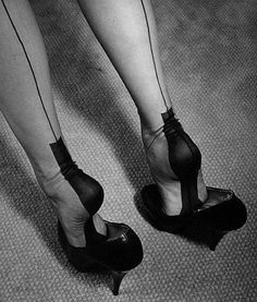 Legs in seamed stockings and high heels on a carpeted floor