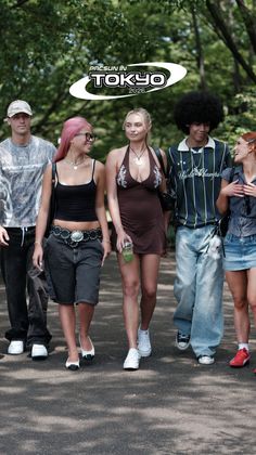 Group of young people walking outdoors, one woman in a halter dress with cleavage