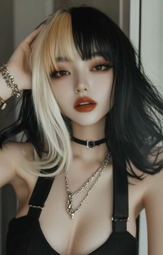 Woman with split black and blonde hair, wearing a choker and necklace
