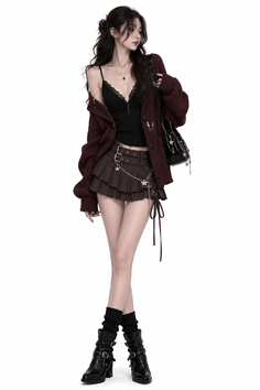 Woman in a dark red cardigan, lace top, and mini skirt with boots