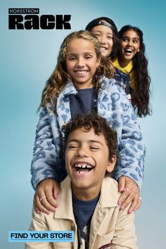 Four children with happy expressions against a blue background