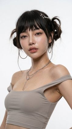 Woman with pigtails and hoop earrings wearing an off-shoulder top