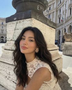 Woman with long wavy hair and a lace dress outdoors in daylight