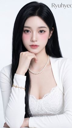 Woman with long black hair wearing a pearl necklace and white lace top