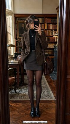 Woman in a tweed blazer and mini skirt taking a mirror selfie in a library