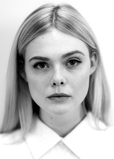 Woman with blonde hair wearing a white shirt in a black and white portrait