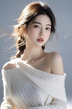 Woman in an off-shoulder white sweater with soft lighting and exposed shoulders