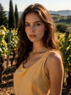 Woman with long hair in a vineyard during golden hour