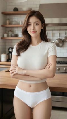 Woman in a white t-shirt and underwear standing in a kitchen