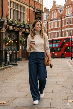 Woman in a turtleneck sweater and wide leg pants walking on a city street