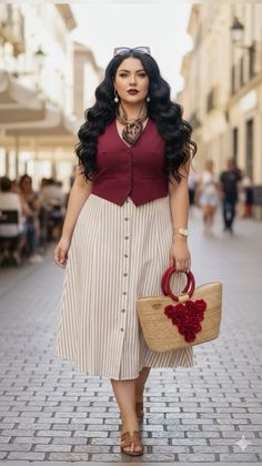 Woman with long wavy hair in a striped skirt and red vest walking on a cobblestone street
