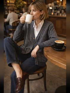 Woman with short hair drinking coffee in a coffee shop