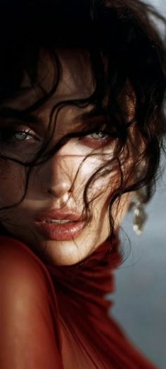 Close up portrait of a woman with curly dark hair and dramatic lighting