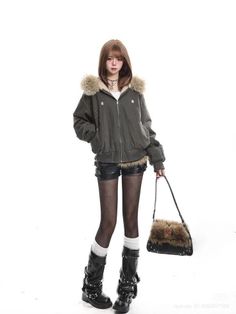 Woman in a fur-lined jacket, leather shorts, and tall boots holding a furry bag