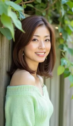 Woman with medium brown hair wearing an off-shoulder green sweater outdoors