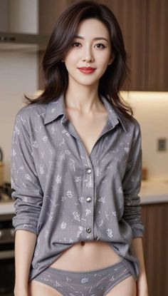 Woman in a gray shirt and underwear with exposed midriff indoors