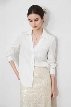 Woman in a white shirt with lace trim and a sequin skirt