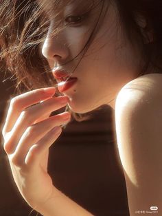 Close up of a woman with short hair and red lipstick in golden hour light