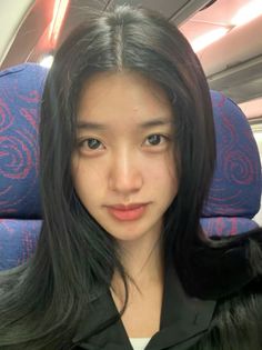 Woman with long black hair in an airplane interior