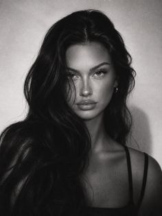 Black and white portrait of a woman with long dark hair and a nose ring