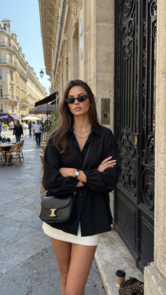 Woman in a black shirt and white mini skirt on a city street