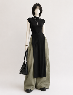 Mannequin wearing a black top with wide leg pants and a cross necklace