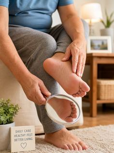 Person examining their foot with a magnifying glass indoors