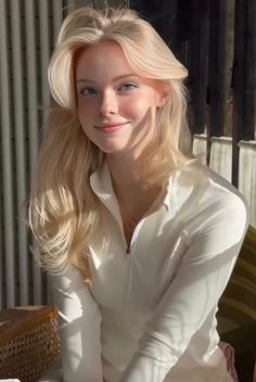 Blonde woman in a white shirt with soft lighting indoors