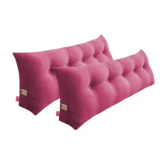 Two pink tufted wedge pillows with side pockets